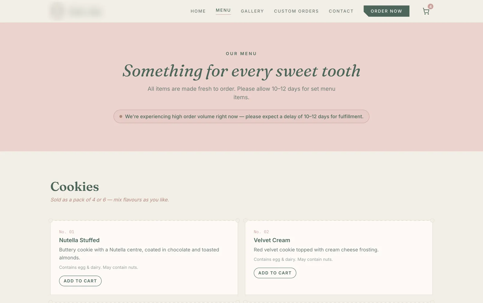 Menu page of a bakery ordering site. A pink banner reads Something for every sweet tooth with a notice about a 10 to 12 day fulfilment delay, above a Cookies section where each item has an Add to Cart button.